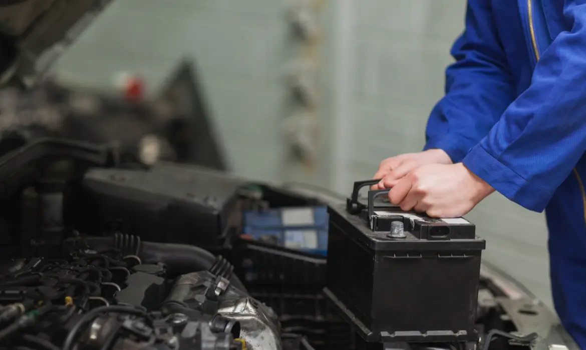 Mechanic replacing a car battery